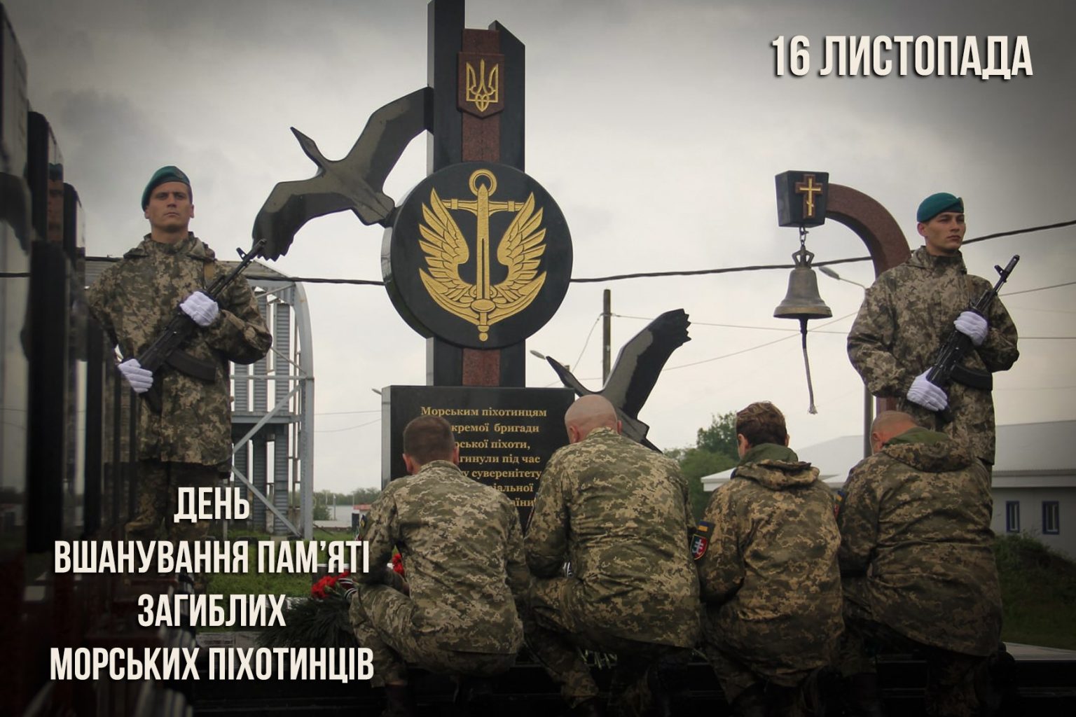 Пам'ятник на честь загиблих морських піхотинців. Двоє військовослужбовців у камуфляжі стоять у почесній варті, а четверо їхніх побратимів присіли перед монументом, прикрашеним гербом Військово-морських сил України. Вгорі напис: 16 ЛИСТОПАДА та ДЕНЬ ВШАНУВАННЯ ПАМ'ЯТІ ЗАГИБЛИХ МОРСЬКИХ ПІХОТИНЦІВ.