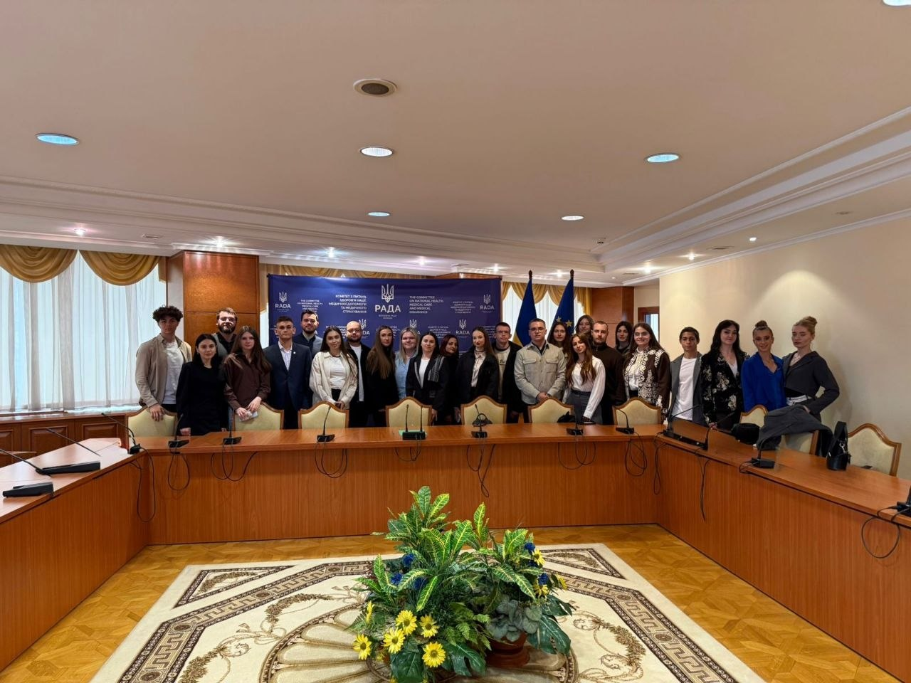 Групове фото учасників офіційної зустрічі в конференц-залі Верховної Ради України. Люди стоять за довгим П-подібним столом для переговорів на фоні синього банера з державною символікою та прапорів України та ЄС.