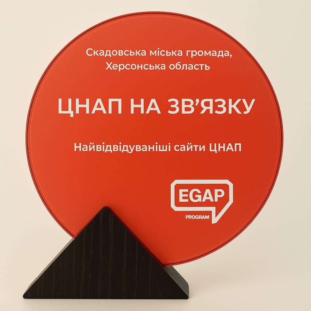 Кругла червона табличка з написом: Скадовська міська громада, Херсонська область, ЦНАП НА ЗВ'ЯЗКУ, Найвідвідуваніші сайти ЦНАП та логотипом EGAP PROGRAM.